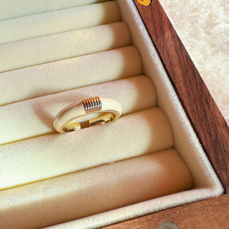 Gold ring with a textured band in an open jewelry box