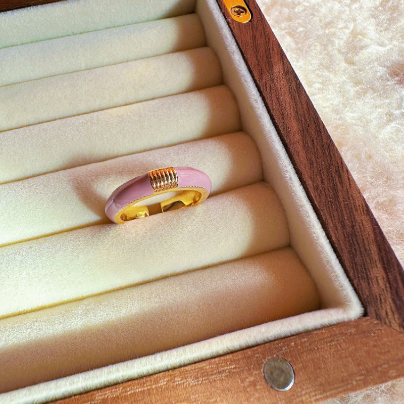 Pink ring with gold accents in a jewelry box