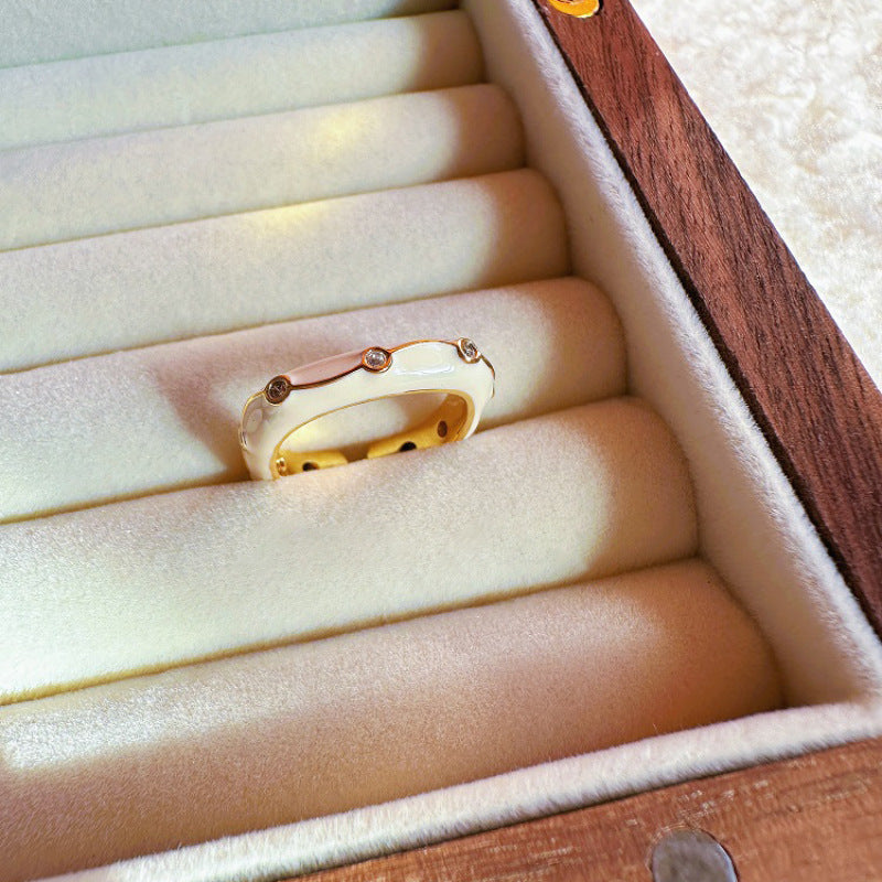 Gold ring with small diamonds in a wooden jewelry box