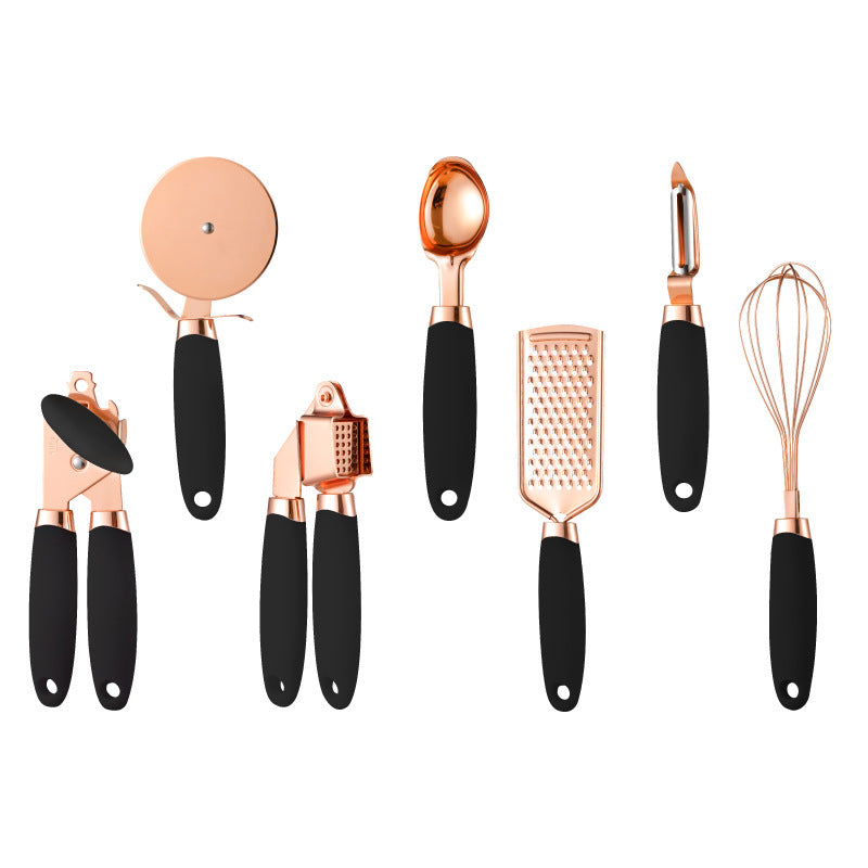Set of rose gold kitchen utensils with black handles on a white background