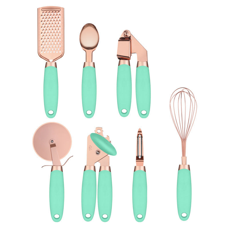 Set of kitchen utensils with rose gold and mint green handles on a white background