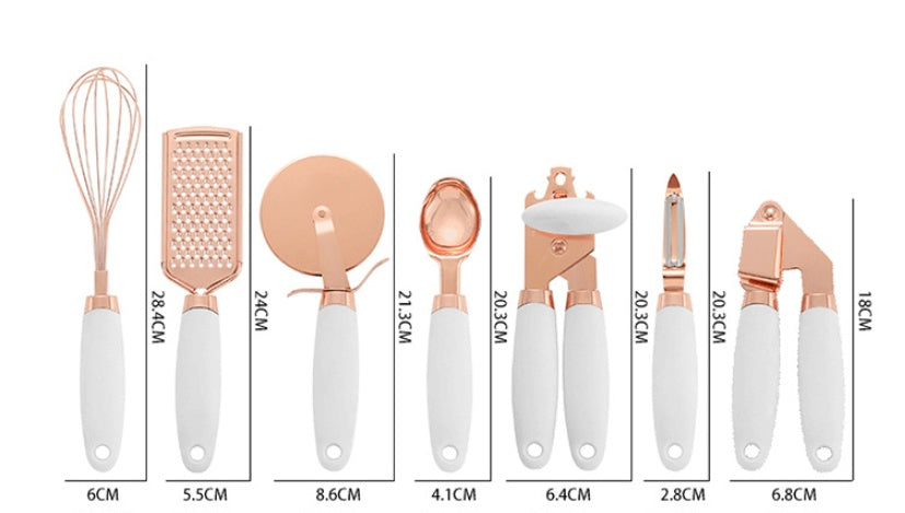 Set of rose gold and white kitchen utensils with measurements on a white background