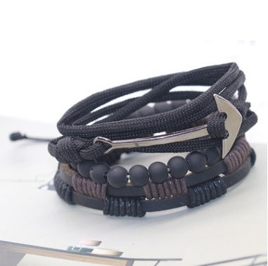 Multistrand bracelet with an anchor charm on a white background