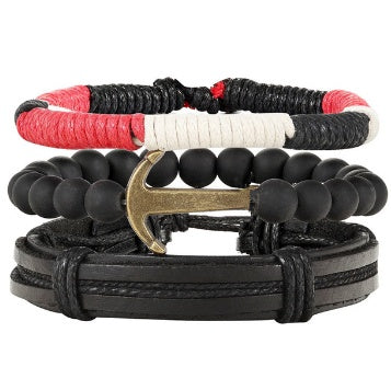 Stack of multistrand bracelets with black, red, and white cords on a white background