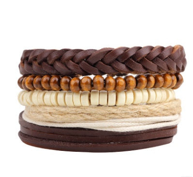 Stack of leather and beaded bracelets on a white background