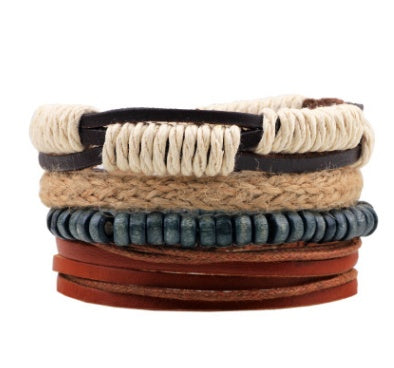 Stack of various leather and beaded bracelets on a white background