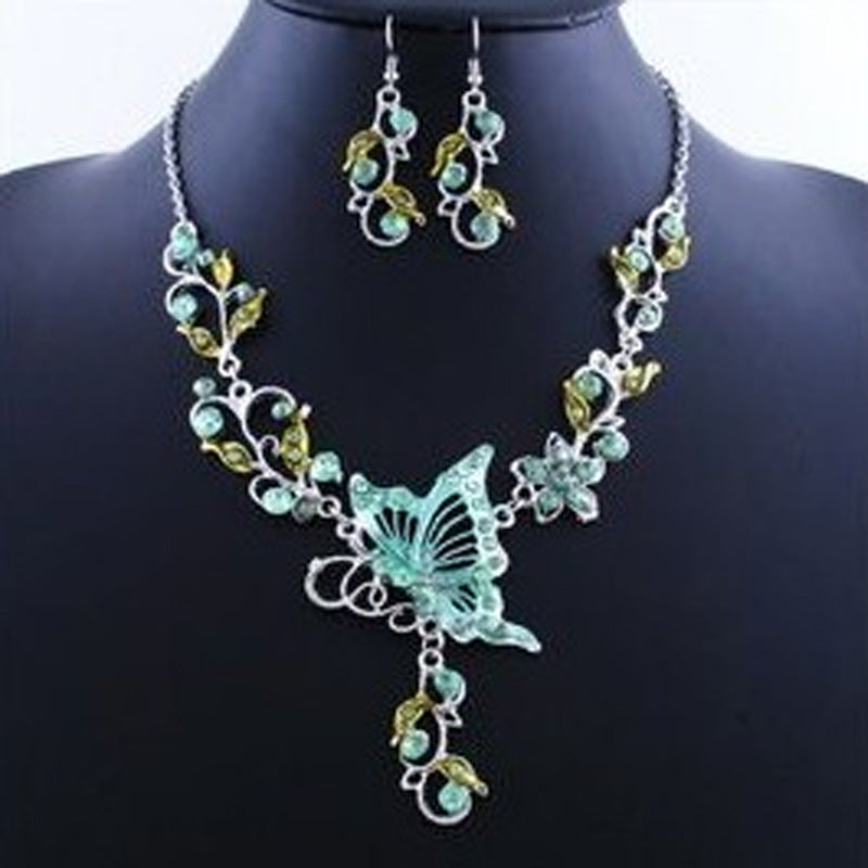 Jewelry set with butterfly design on a mannequin