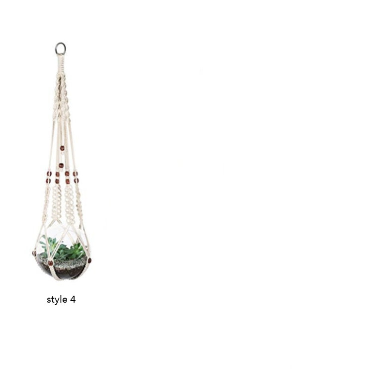 Hanging plant holder with a plant on a white background