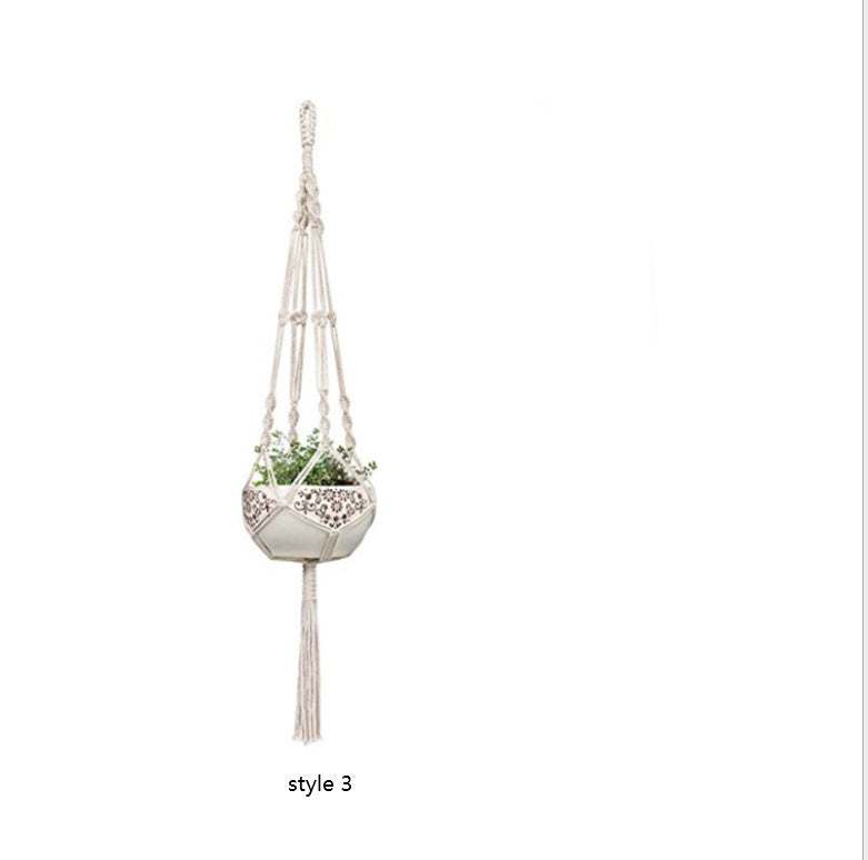 Macrame plant hanger with a decorative pot on a white background