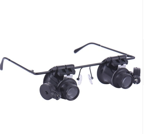 Pair of magnifying glasses with adjustable arms on a white background