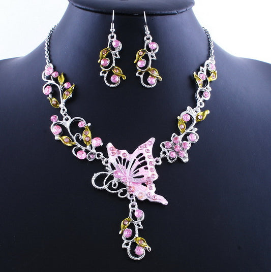 Jewelry set with pink butterfly necklace and earrings on a black mannequin.