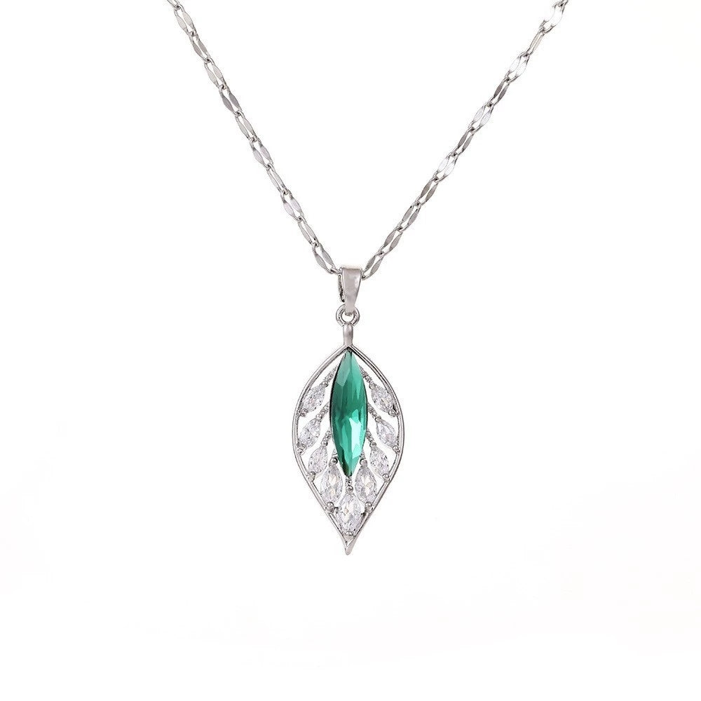 Silver necklace with a green gemstone pendant on a white background