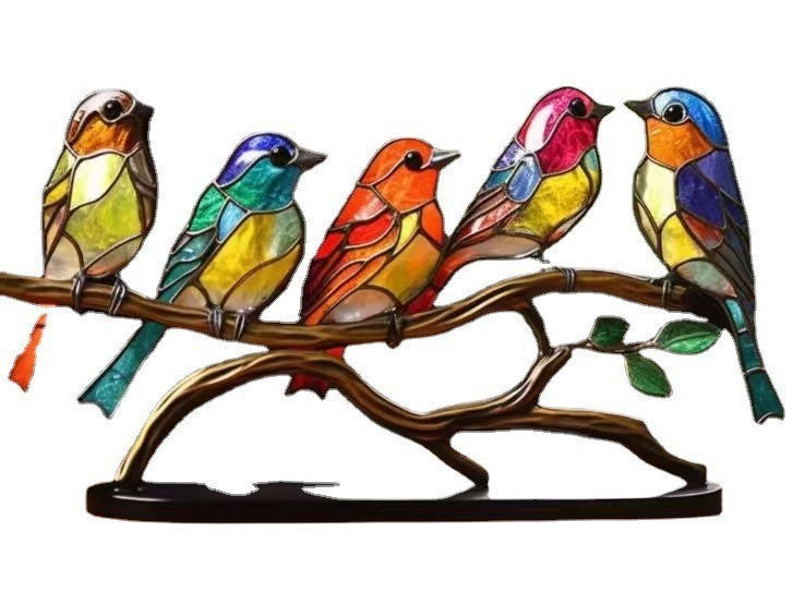 Colorful stained glass birds on a branch with a white background