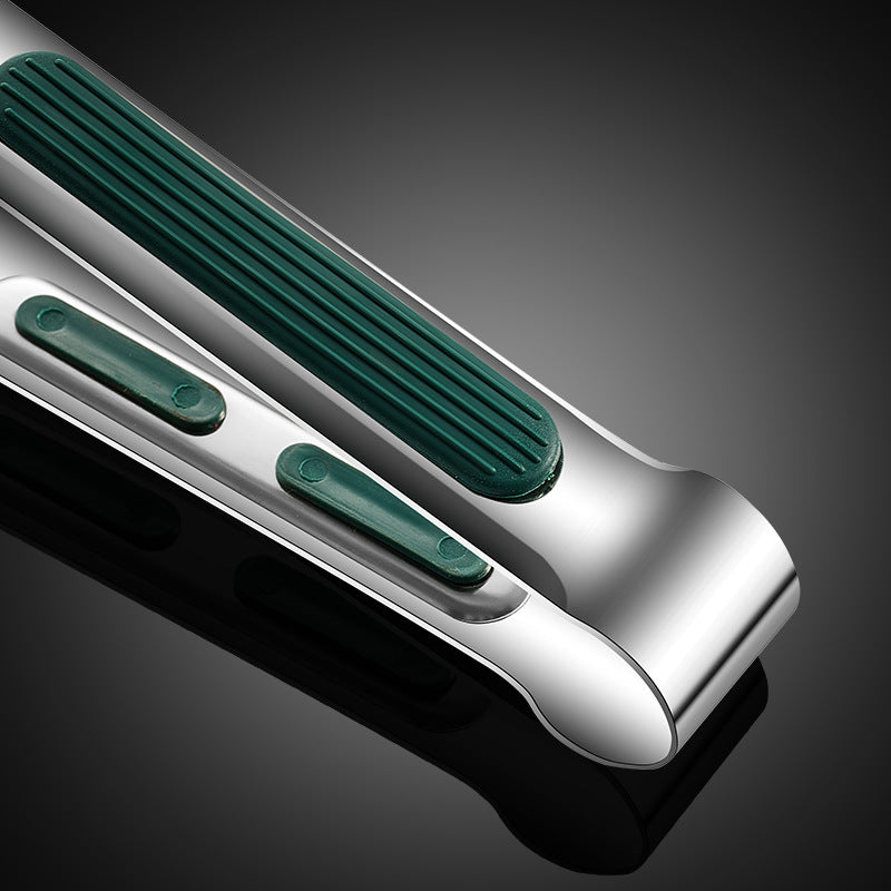 Close-up of a metallic object with green accents on a dark background