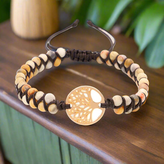 Bracelet with natural bead design and gold tree-shaped clasp on a white background