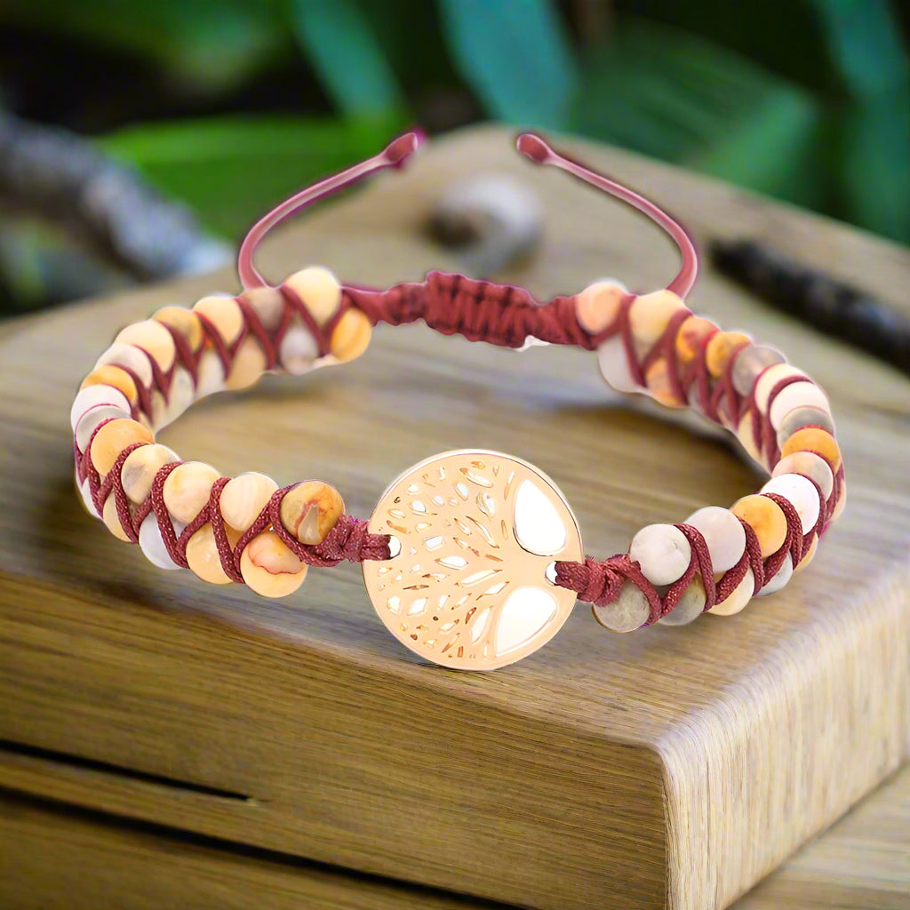 Bracelet with beads and a gold heart-shaped clasp on a white background